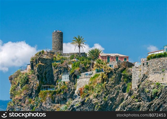 The old medieval tower on a hill in the village Vernazza. Cinque Terre National Park, Liguria, Italy.