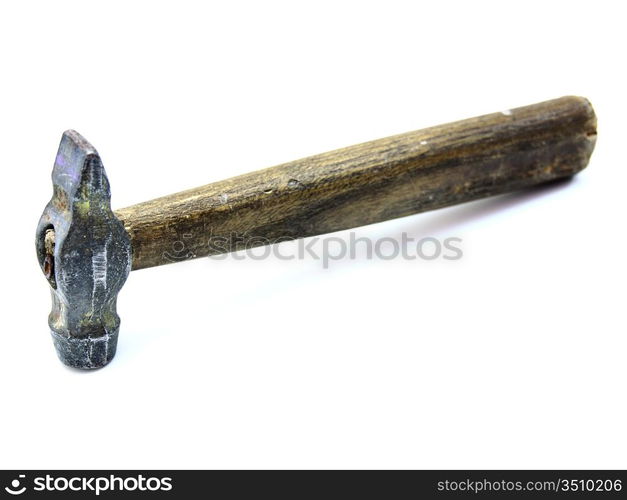 The old metal hammer with the wooden handle lies on a white background