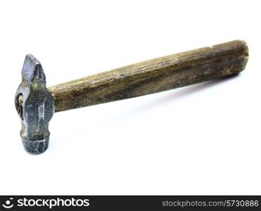 The old metal hammer with the wooden handle lies on a white background