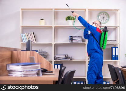 The old professional contractor doing pest control in the office. Old professional contractor doing pest control in the office