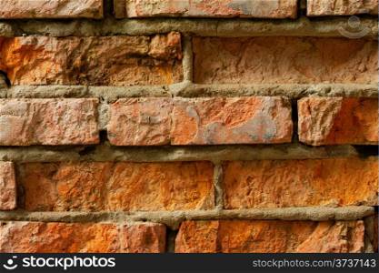 The old red brick wall with cracks