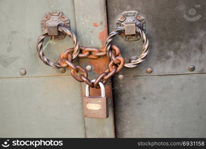 The Old rusted metal lock in metal chains