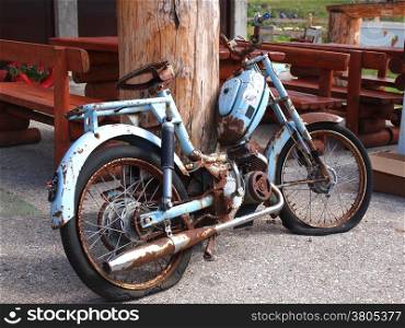 the old, rusty motorcycle on a street