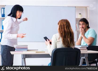 The old teacher and students in the classroom . Old teacher and students in the classroom