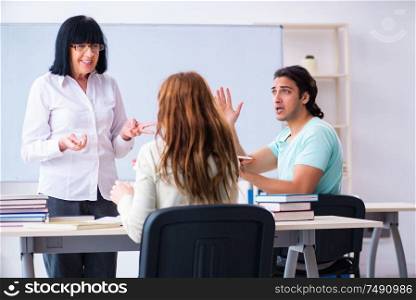 The old teacher and students in the classroom. Old teacher and students in the classroom
