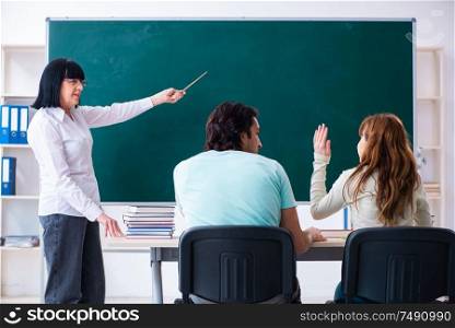 The old teacher and students in the classroom. Old teacher and students in the classroom