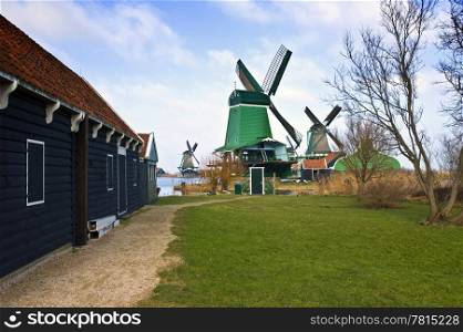 "The old, typically Dutch windmills and barn at the tourist attraction "De Zaanse Schans" on a nice winter day"