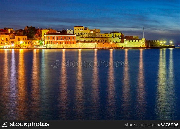 The old Venetian harbor of Chania night.. The picturesque view of the old port with the waterfront of Chania in the moonlight. Crete, Greece.