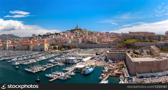 The old Vieux Port and Basilica Notre Dame de la Garde in the historical city center of Marseilles on sunny day, France. Old Port and Notre Dame, Marseille, France