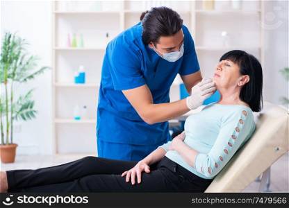 The old woman visiting male doctor for plastic surgery . Old woman visiting male doctor for plastic surgery