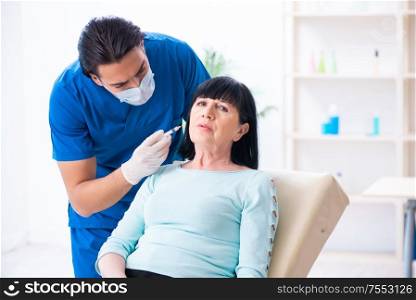 The old woman visiting male doctor for plastic surgery. Old woman visiting male doctor for plastic surgery