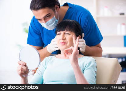 The old woman visiting male doctor for plastic surgery. Old woman visiting male doctor for plastic surgery