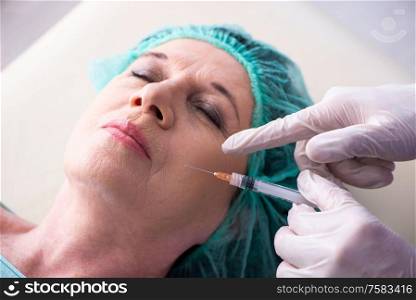 The old woman visiting male doctor for plastic surgery. Old woman visiting male doctor for plastic surgery