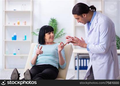 The old woman visiting young doctor dentist. Old woman visiting young doctor dentist