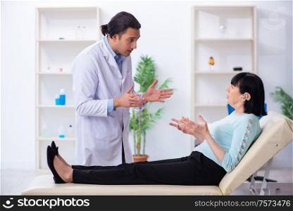 The old woman visiting young doctor laryngologist. Old woman visiting young doctor laryngologist