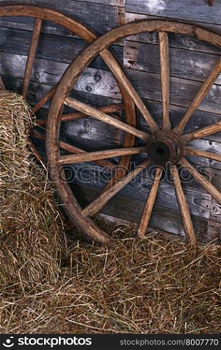 The old wooden wheel on a hay