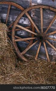 The old wooden wheel on a hay