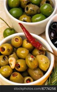 The Olive is a small oval fruit with a hard stone and bitter flesh, green when unripe and bluish black when ripe, used as food and as a source of oil.