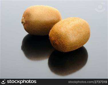 The pair of Kiwi and their reflection on a black background