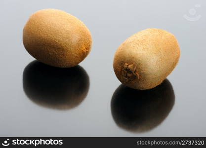 The pair of Kiwi and their reflection on a black background