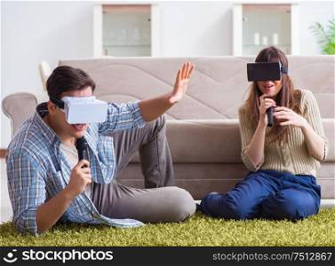 The pair singing karaoke with virtual reality glasses. Pair singing karaoke with virtual reality glasses