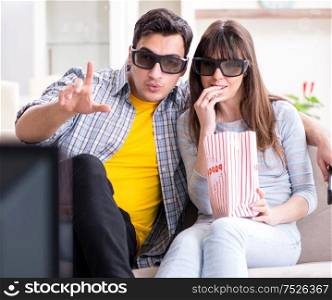 The pair watching 3d movie at home. Pair watching 3d movie at home