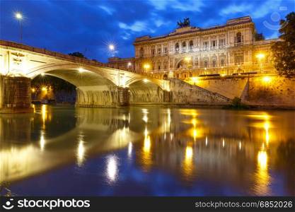 The Palace of Justice in Rome, Italy. The Palace of Justice and bridge Ponte Umberto I with mirror reflection in Tiber River during morning blue hour in Rome, Italy