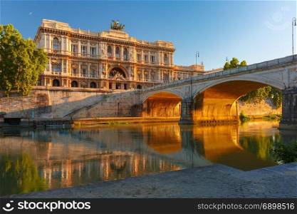 The Palace of Justice in Rome, Italy. The Palace of Justice and bridge Ponte Umberto I with mirror reflection seen from the Tiber riverside at sunrise in Rome, Italy