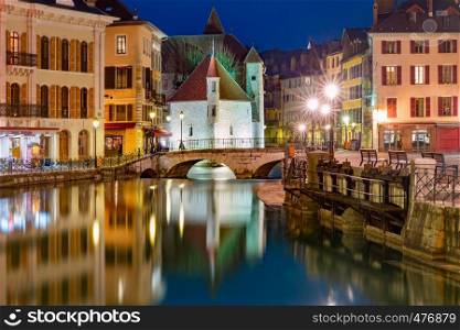 The Palais de l'Isle and Thiou river at night in old city of Annecy, Venice of the Alps, France. Annecy, called Venice of the Alps, France
