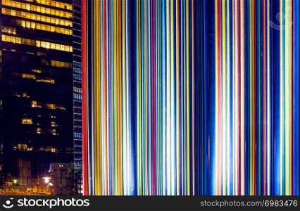 The Paris city at night. Street lights and glass business towers, France. Le Moretti-artistic column