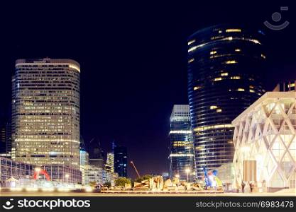"The Paris city at night. Street lights and glass business towers, France. The "coeur defense" tower"