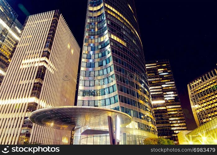 The Paris city at night. Street lights and glass business towers, France. The city of Paris at night