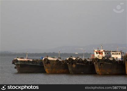 The parking of the old cargo ships stand. Cemetery of the old ships India, Goa.