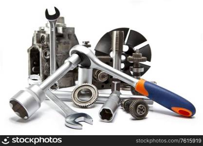 the part of car high pressure pump and the tool for repair on white background