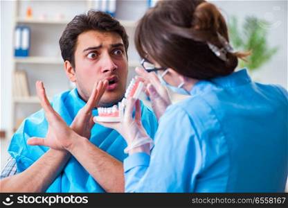 The patient afraid of dentist during doctor visit. Patient afraid of dentist during doctor visit