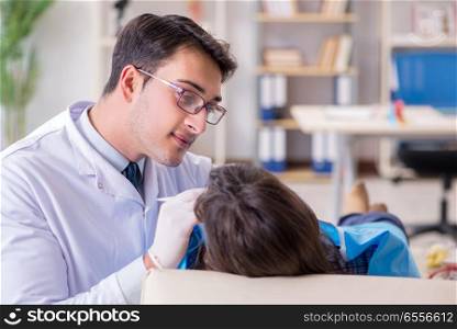 The patient visiting dentist for regular check-up and filling. Patient visiting dentist for regular check-up and filling