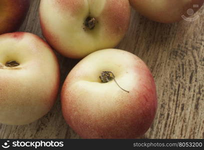 The peaches on the Board. Peaches are an old wooden surface