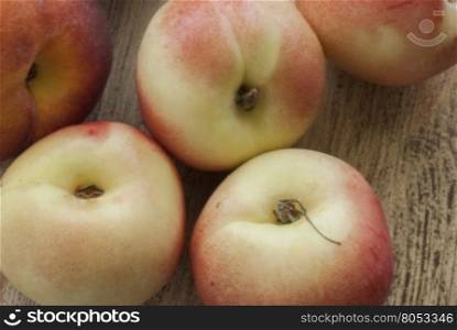 The peaches on the Board. Peaches are an old wooden surface