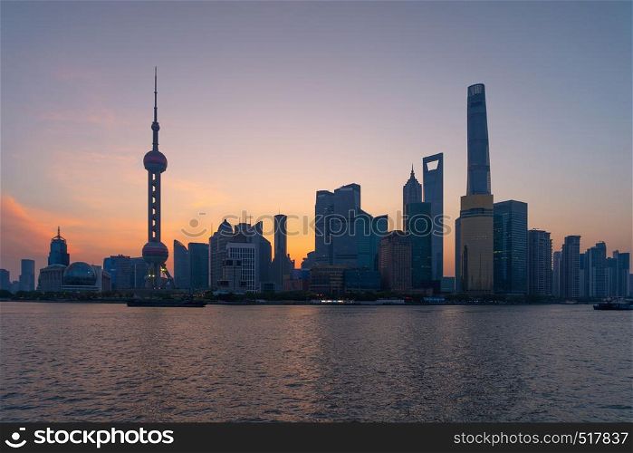 The Pearl in Shanghai Downtown skyline by Huangpu River, China. Financial district and business centers in smart city in Asia. Skyscraper and high-rise buildings near The Bund at sunrise.