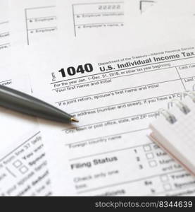 The pen and notebook is lies on the tax form 1040 U.S. Individual Income Tax Return. The time to pay taxes