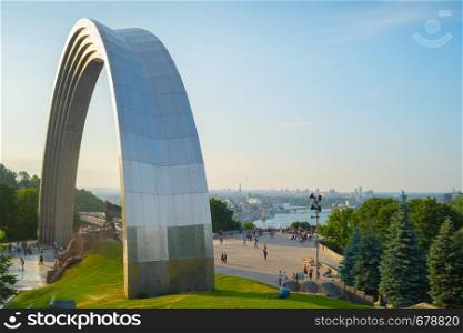 The People's Friendship Arch is a monument in Kiev, Ukraine. Skyline of Podol in the background