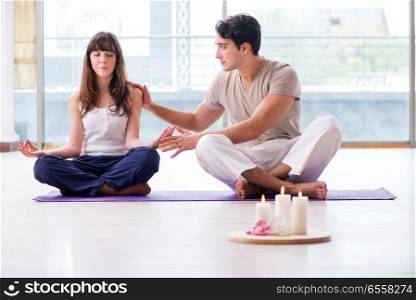 The personal coach helping during yoga session. Personal coach helping during yoga session