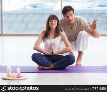 The personal coach helping during yoga session. Personal coach helping during yoga session