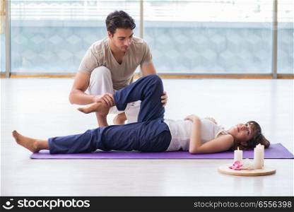 The personal trainer assisting during exercise in sports gym. Personal trainer assisting during exercise in sports gym