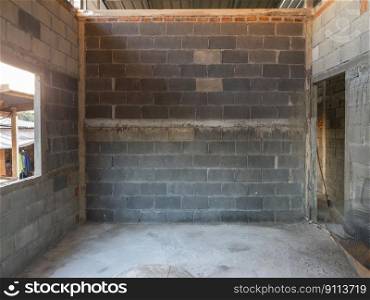 The perspective view of the block wall in the empty room which is under construction in the rural village, front view with the copy space.