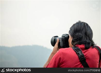 The photographer is photographing the mountain on his travels.