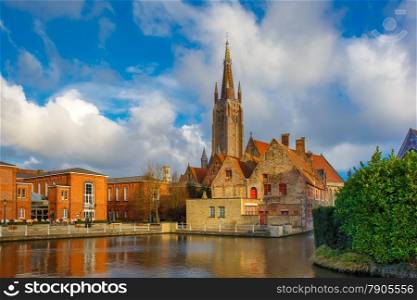 The picturesque city landscape with a lake, Old St. John&#39;s Hospital and the Church of Our Lady in Bruges, Belgium