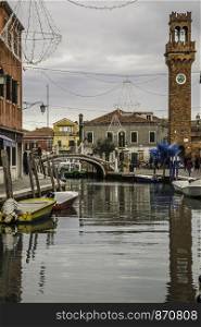 The picturesque island of Murano in the Venetian Lagoon is interwoven with canals and narrow streets between historic houses and palaces with beautiful gardens. Venice, Italy