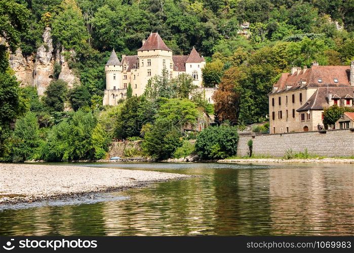 The picturesque medieval village of La Roque Gageac nestled in the cliff and reflecting in Dordogne river
