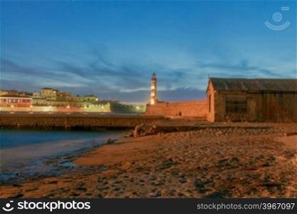 The picturesque view of the old port with lighthouse of Chania in the twilight. Crete, Greece.